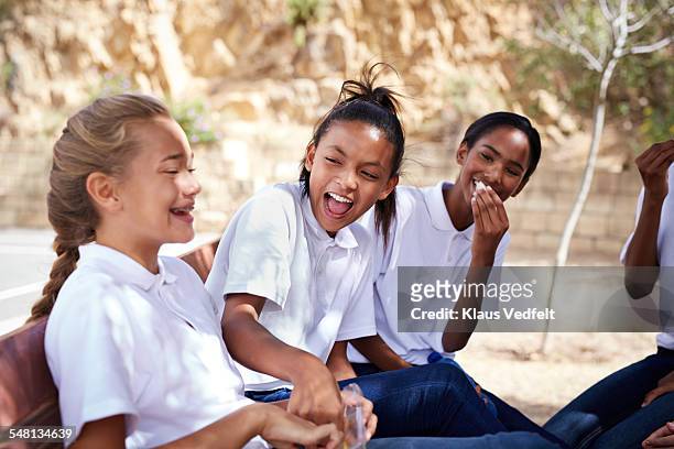 Schoolgirls laughing together in their break