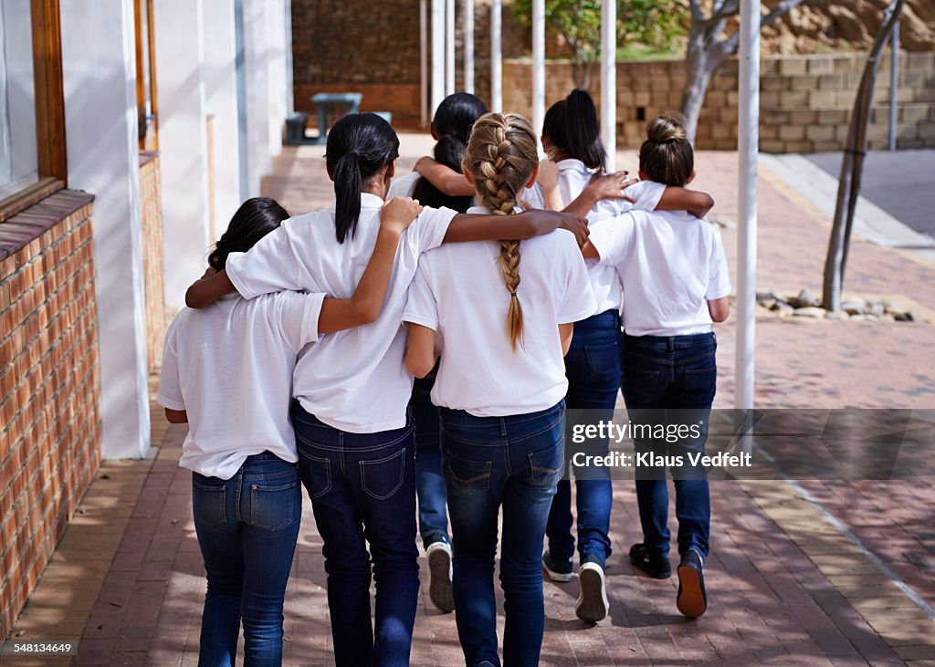 Female students walking together in schoolyard