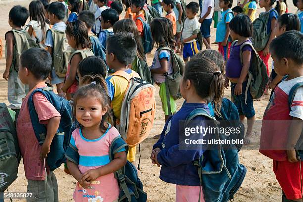 Ecuador Curaray - village without any road connection in the rainforest of the Oriente, 150 km east of Puyo. Students muster in the schoolyard before...