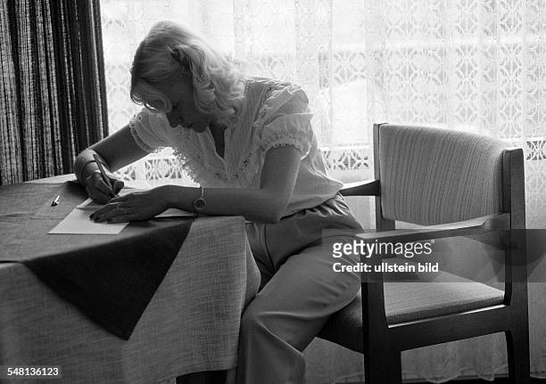 People, young woman sits at a table writing a letter, backlight, twilight, aged 25 to 35 years, Elisabeth -