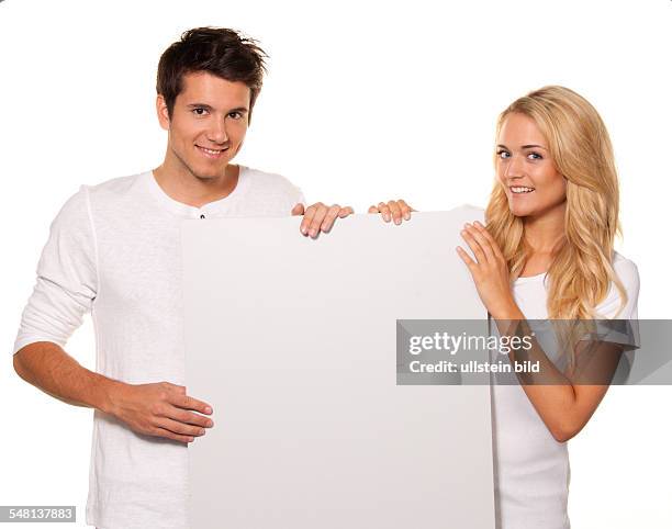 Couple with blank poster to advertise the opening and offers -