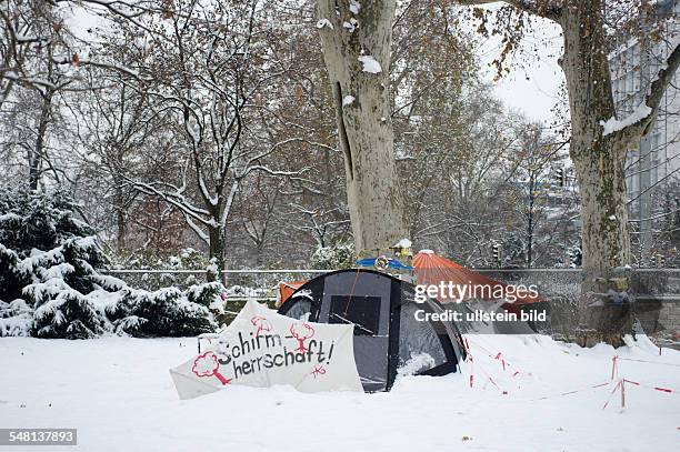 Germany Baden-Wuerttemberg Stuttgart - project Stuttgart 21; tents of the park protectors in the snowy palace garden