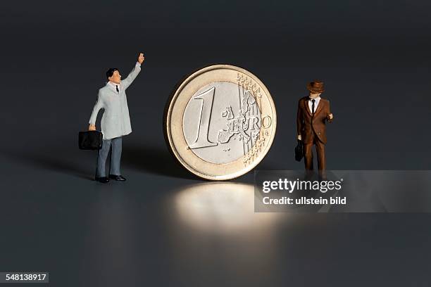 Euro coin and businessmen