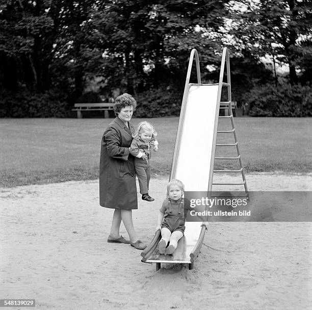 People, older woman and two grandchildren on the playground, slide, aged 50 to 60 years, aged 3 to 4 years -