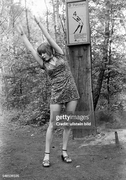 People, health, young woman on a keep-fit trail in the forest, gymnastic exercises outdoors, aged 20 to 25 years, Monika -