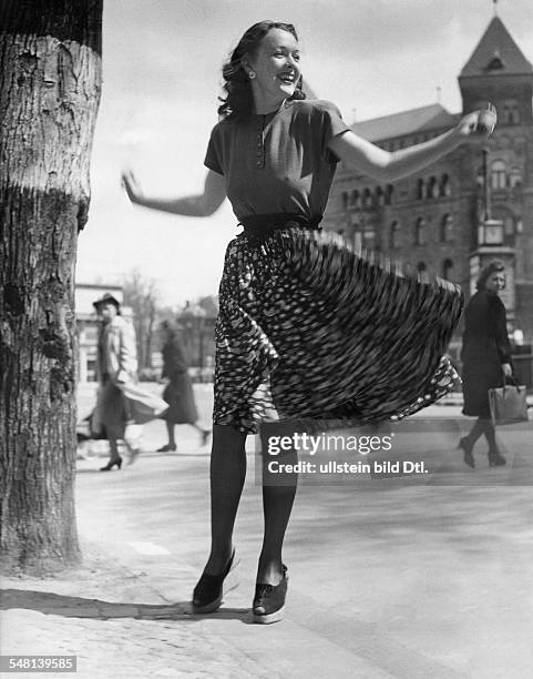 Young woman with colorful wind blown silk skirt - 1942 - Photographer: Regine Relang - Published by: 'Berliner Illustrirte Zeitung' 20/1942 Vintage...