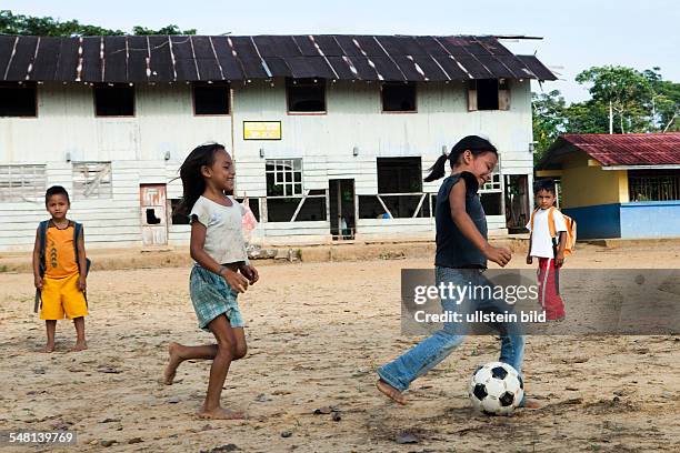 Ecuador Curaray - A village without any road connection in the rainforest of the Oriente, 150 km east of Puyo. Kids playing soccer in the schoolyard...