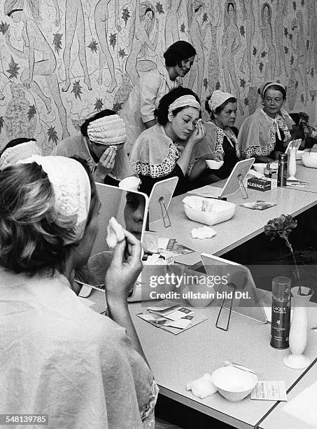 Ile de France Paris: Women applying makeup on their faces during a training course in the 'School of Beauty' in Paris - 1965 - Vintage property of...