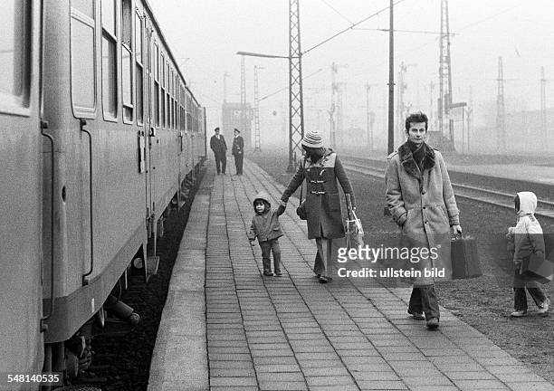 Rail traffic, main railroad station Bottrop, young family with two children dismounted the train and walks along the platform to the station exit,...