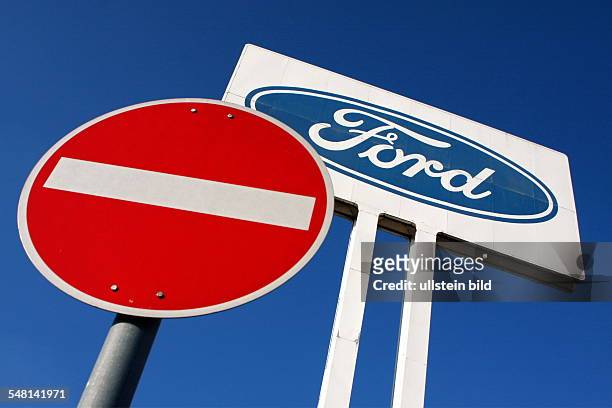 Ford logo and stop traffic sign at headquarters Ford Germany