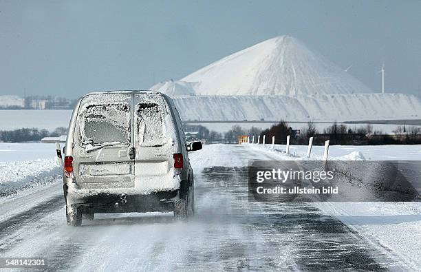 Germany Saxony-Anhalt - car is driving on a snowy local road near Mansfeld