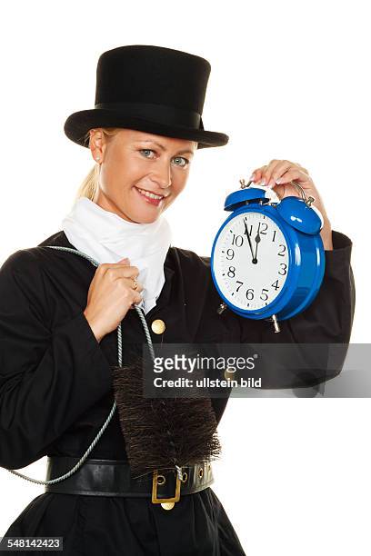 Symbolic pho New Year's Eve, woman as chimney sweeper with alarm clock -