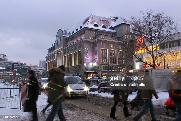 Germany Berlin Charlottenburg - pedestrians are crossing the snowed in road Tauentzienstrasse, in the background the department store Kaufhaus des...