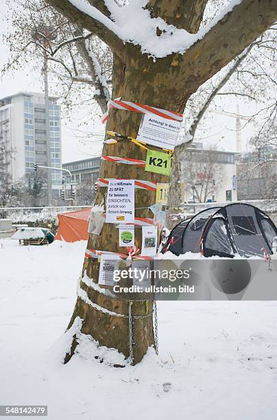 Germany Baden-Wuerttemberg Stuttgart - project Stuttgart 21; protest posters and flyer on a tree at castle garden