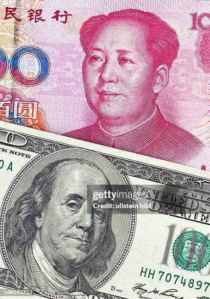 Chinese Yuan Renminbi and Dollar banknotes with portraits of Mao Zedong and Benjamin Franklin