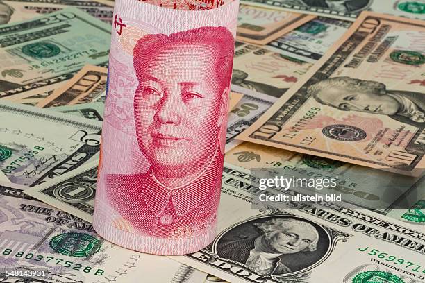 Chinese Yuan Renminbi with portrait of Mao Zedong and Dollar banknotes with portrait of George Washington