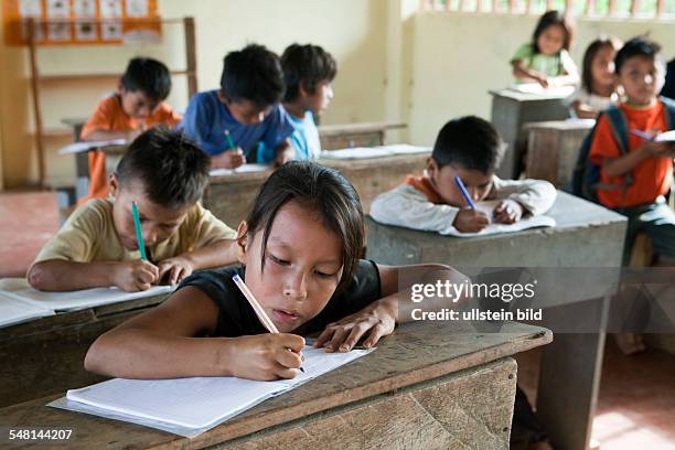 Ecuador Curaray - primary school in a village without any road connection in the rainforest of the Oriente, 150 km east of Puyo. Students learn to...