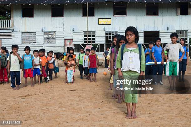 Ecuador Curaray - village without any road connection in the rainforest of the Oriente, 150 km east of Puyo. Students muster in the schoolyard before...