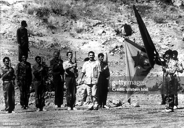 Abdullah Öcalan , leader of the PKK, is taking the salute of his guerilla fighters in Kurdistan