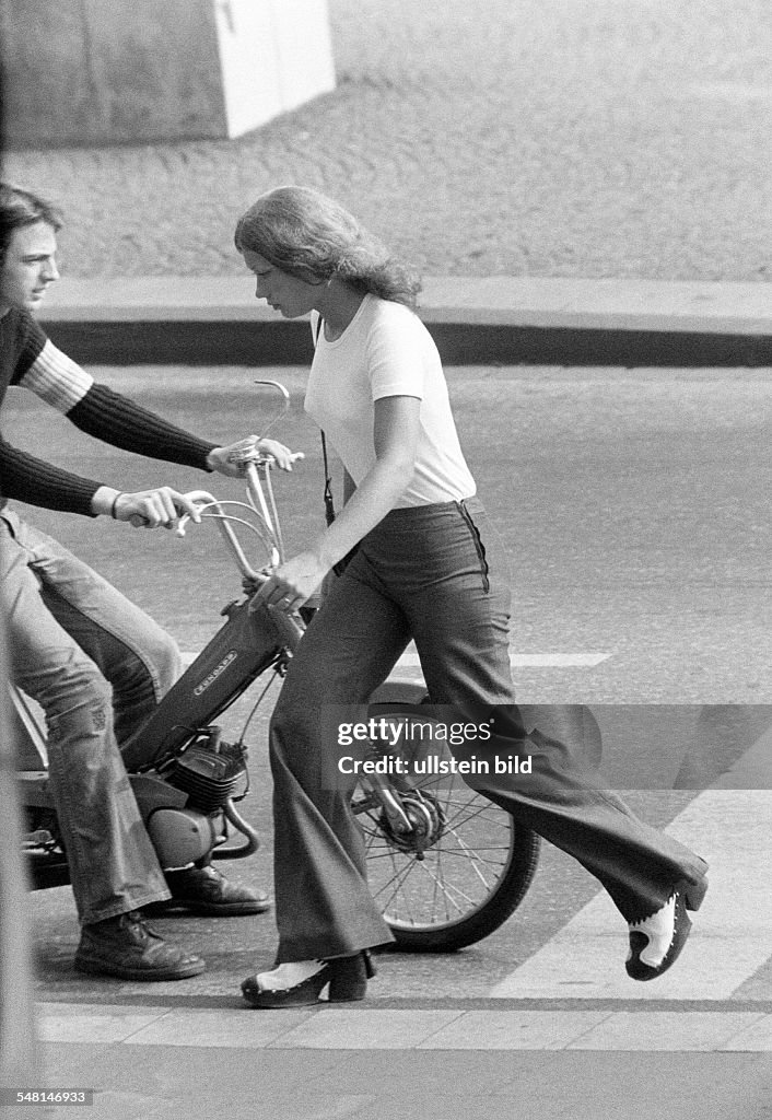 People, young girl crosses the street, young man driving a mofa, T-Shirt, trousers, pullover, jeans trousers, aged 18 to 22 years - 31.08.1973