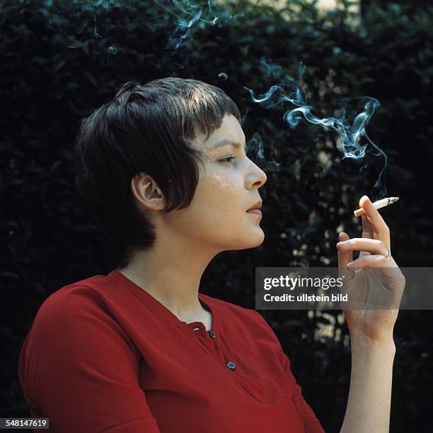 Germany - young girl smoking a cigarette, portrait, profile -