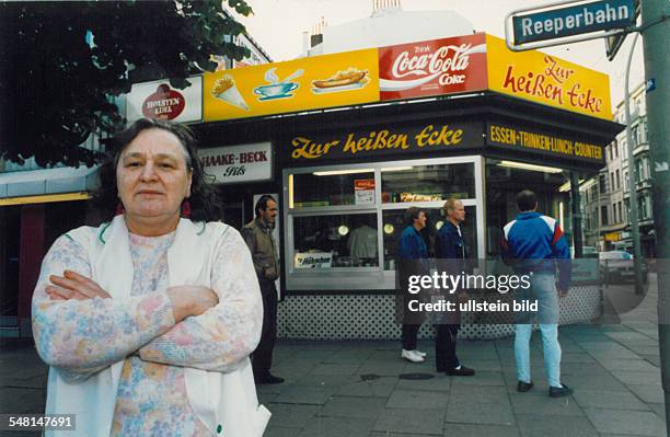 Germany Hamburg St. Pauli - Innkeeper Ella Mehrhoff standing in front of her diner "Zur heissen Ecke"