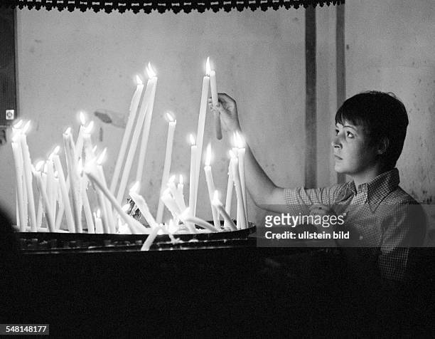 People, death, mourning, remembrance, memorization, young woman lights an offering candle in a church, aged 20 to 30 years, Monika, Spain, Valencia -