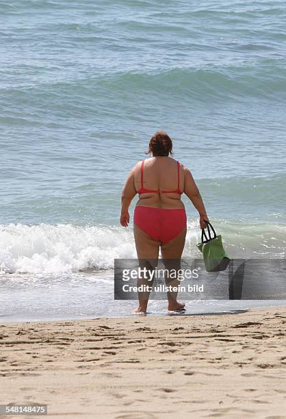 Spain Andalucia Nerja - Corpulent woman wearing a bikini at the beach