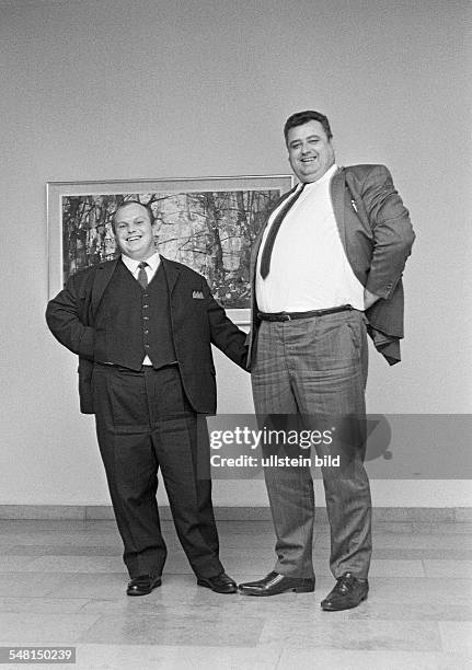 Humour, people, contrast, a runtish man and a large-sized man stand side by side, dwarf and giant, aged 30 to 40 years -