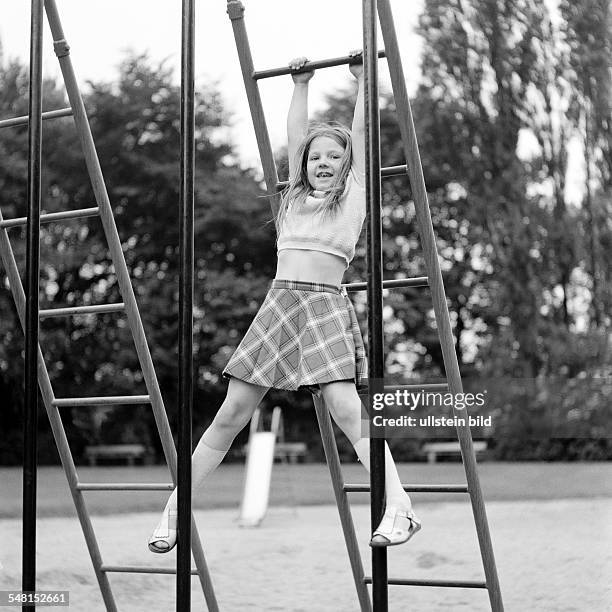 People, children, little girl on monkey bars, childrens playground, aged 5 to 7 years -