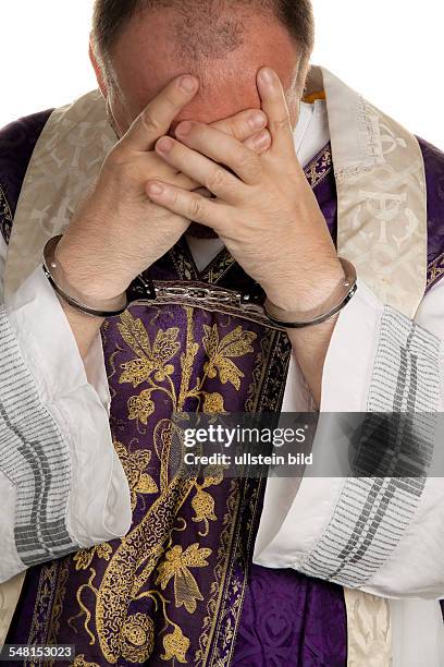 Priest of the Catholic church with handcuffs -