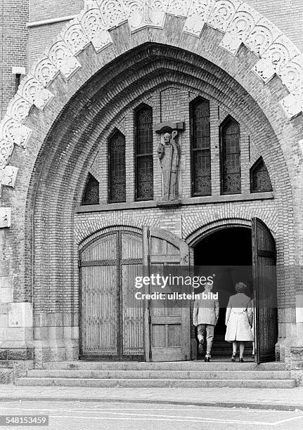 Religion, Christianity, church goers, older man and older woman walk to the church service, aged 60 to 70 years, church portal, Saint-Bavo-Church,...