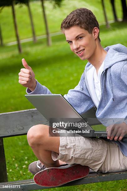 Young man with laptop on a bench - 2010