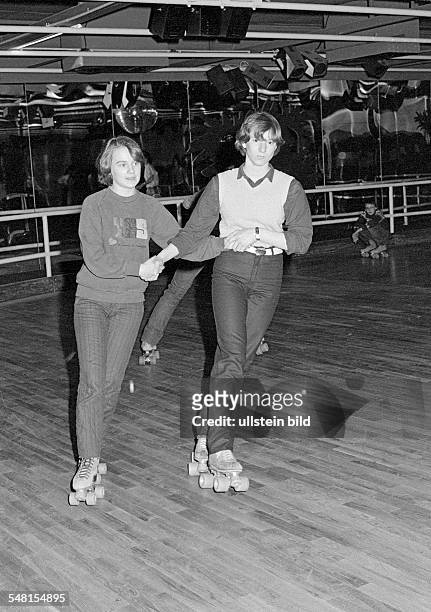 People, young couple on rollerblades in a sports hall, trousers, pulli, aged 15 to 18 years -