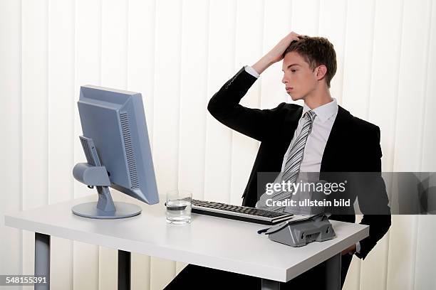 Young man in a suit working at the computer - 2010