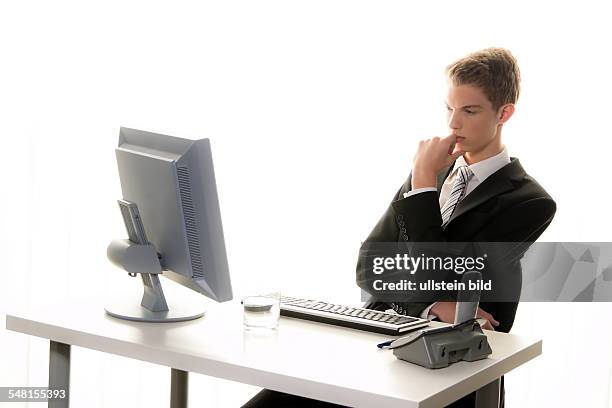 Young man in a suit working at the computer - 2010