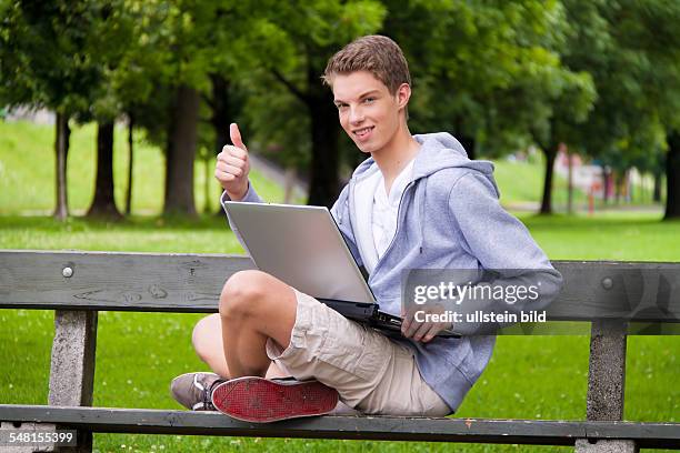 Young man with laptop on a bench - 2010