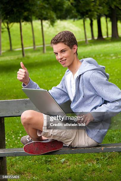 Young man with laptop on a bench - 2010