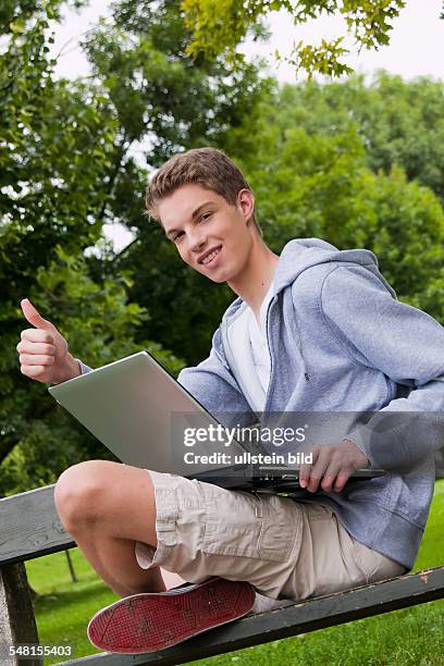 Young man with laptop on a bench - 2010