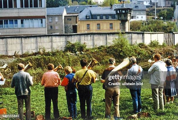 Germany Bavaria - border between FRG - GDR, brass band is playing at wall on the Bavaria area, behind the wall there is the village Blankenstein