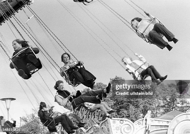 Kermess, people on a chairoplane -