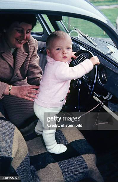 Germany - baby at the steering wheel in a car - 1970