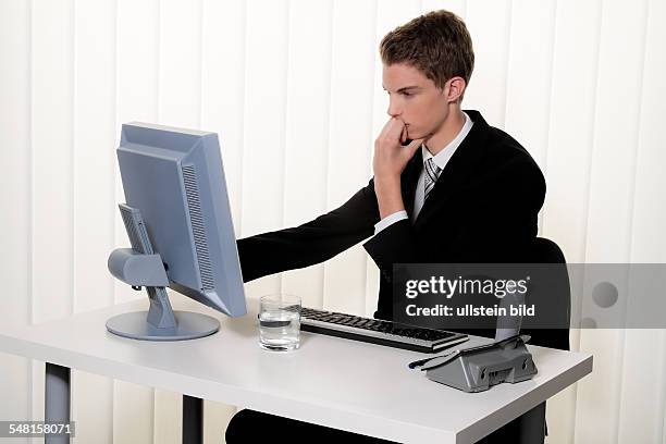 Young man in a suit working at the computer - 2010