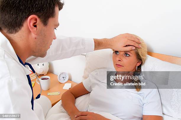 Home visit by the doctor, sick woman in bed -