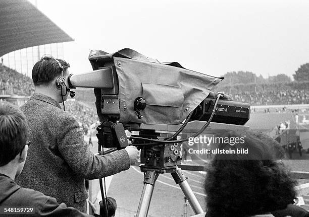 People, media, television, cameraman controlling a TV camera during a sports event in the Wedau Stadium, nowadays MSV Arena, German Championships in...