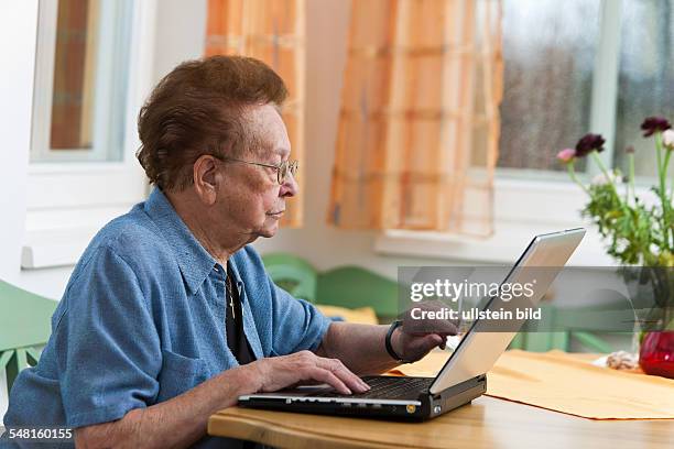 Elderly woman with laptop -