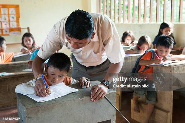 Ecuador Curaray - primary school in a village without any road connection in the rainforest of the Oriente, 150 km east of Puyo. Students learn to...