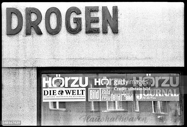 German Democratic Republic Bezirk Berlin East Berlin - chemist shop with the sign 'Drugs' and advertising for newspapers and magazines of...