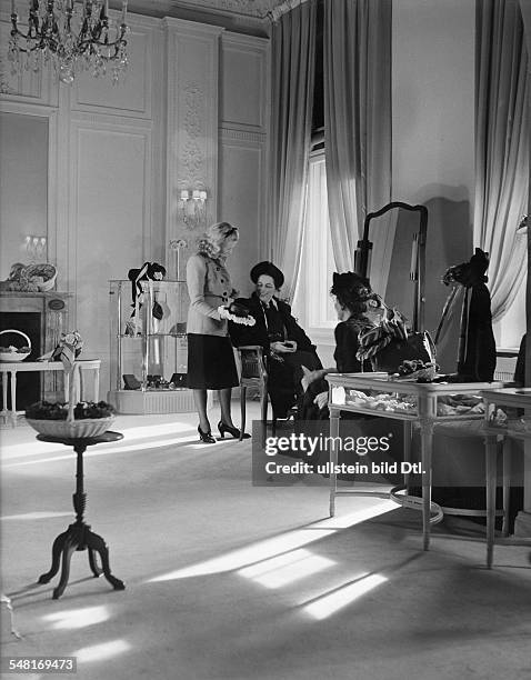 Mrs von Wülfing in the salon of Berlin modiste and hatter Madame Berthe - 1941 - Photographer: Regine Relang - Published by: 'Die Dame' 13/1941...