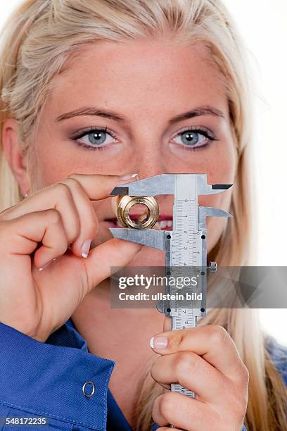 Symbolic photo female craftsman, female do-it-yourselfer, woman in a boilersuit with calliper rule -